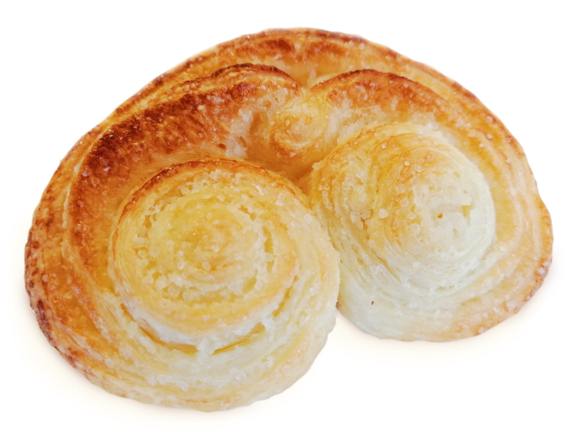 Duże ciastko koloru złocistego, zwinięte po bokach w rulony.