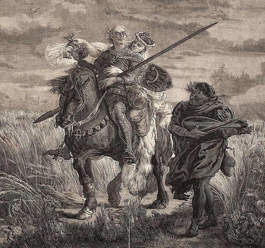 Zdjęcie przedstawia mężczyznę w zbroi, trzymającego włócznie, który siedzi na koniu. Zanim siedzi kobieta. Koń idzie prze pola zboża. Obok idzie lutnik i przygrywa parze jadącej na koniu na instrumencie. 