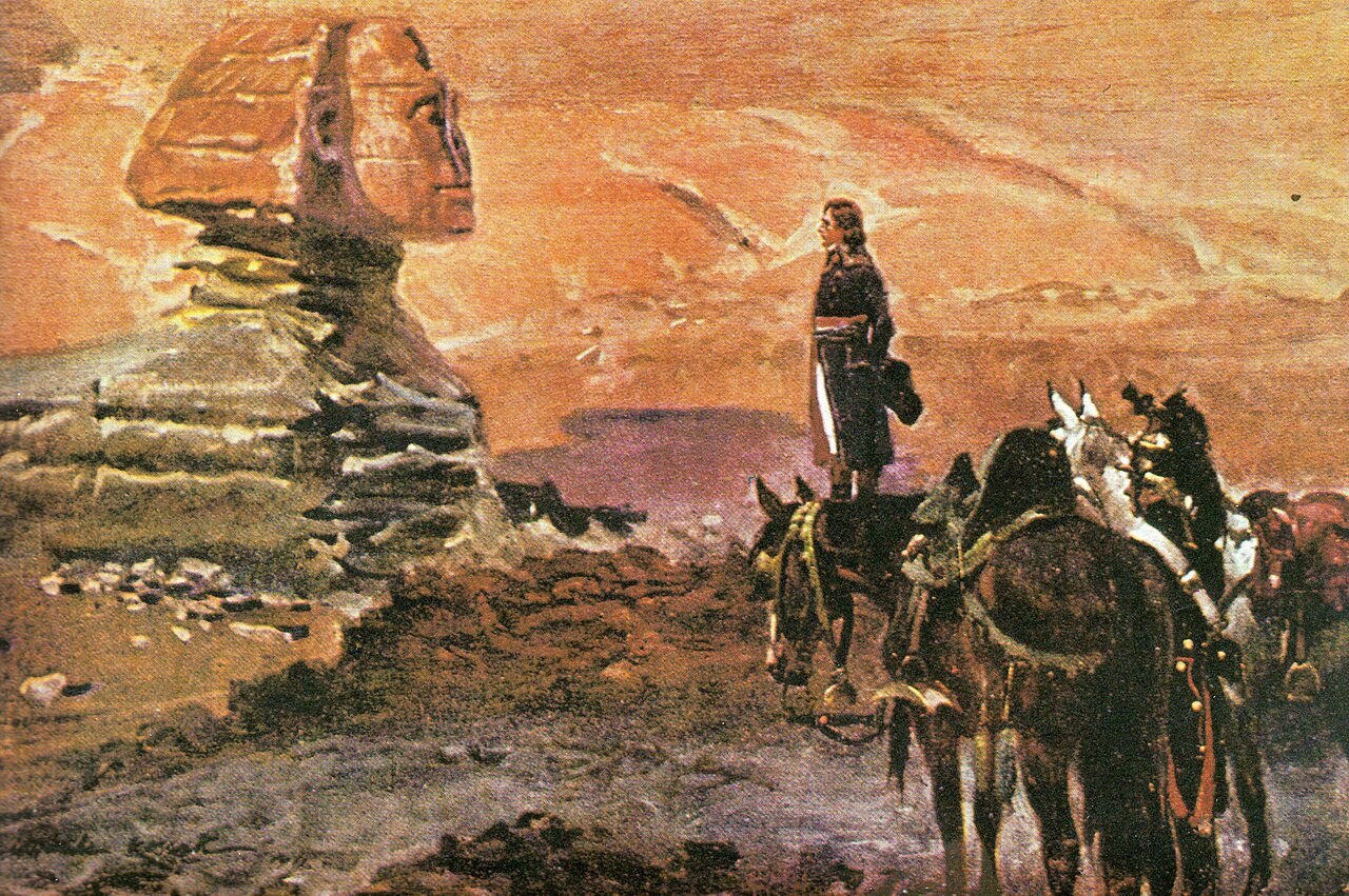 Obraz przedstawia Napoleona w Egipcie. Mężczyzna znajduje się na pustyni. Ubrany w mundur trzyma kapelusz za plecami. Wparuje się w rzeźbę Sfinksa oraz pustynię. Nieopodal niego stoją trzy osiodłane konie.