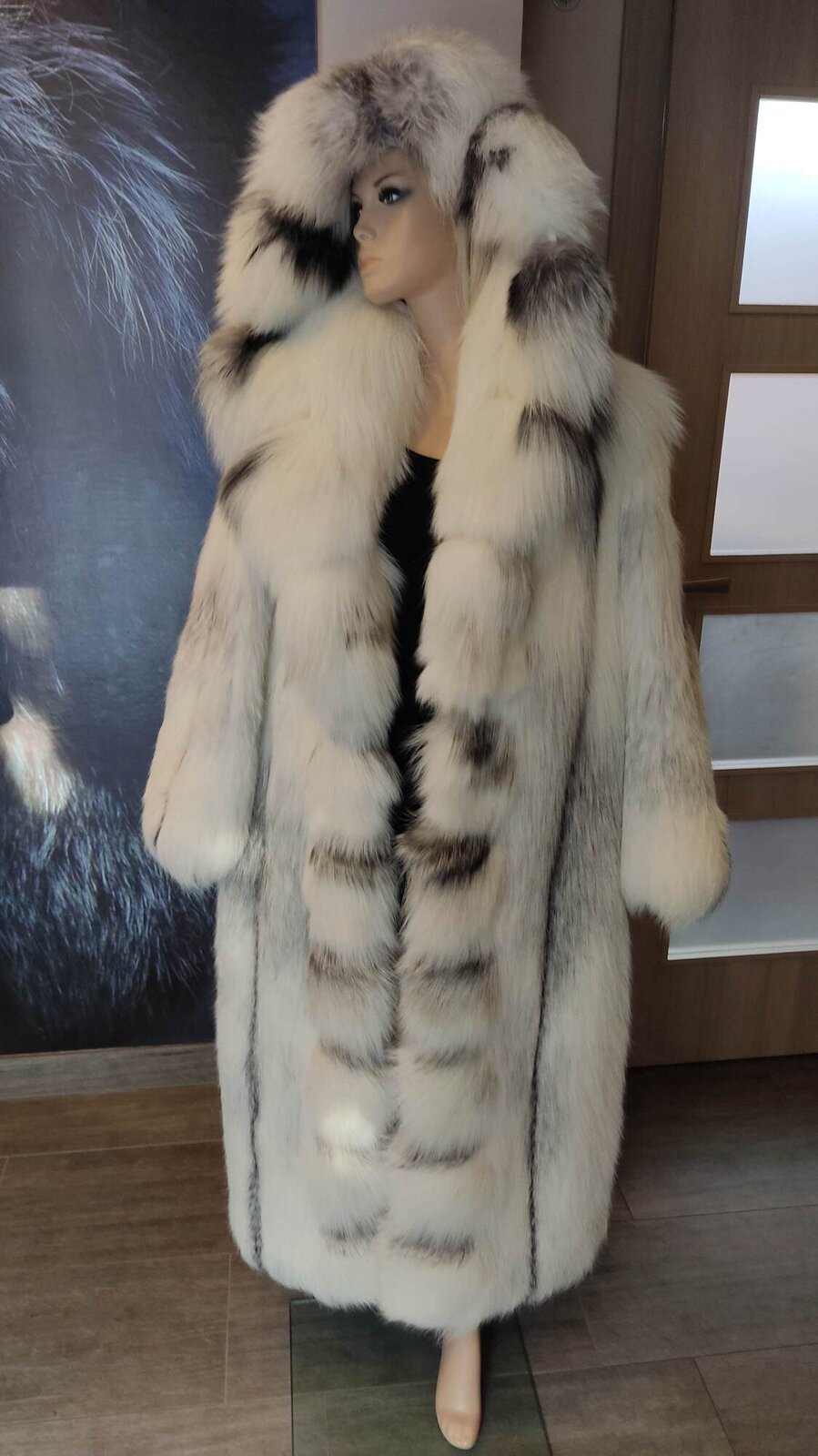 Na zdjęciu widoczne jest długie, beżowe futro z kapturem z ciemniejszymi fragmentami. Nagranie tożsame z treścią.