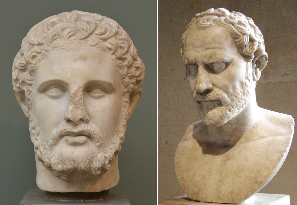 Zdjęcie przedstawia dwie rzeźby. Pierwsza rzeźba przedstawia głowę mężczyzny. Ma on krótkie włosy oraz brodę z wąsami. Rzeźba ma utrącony nos. Druga rzeźba przedstawia popiersie dojrzałego mężczyzny. Ma krótkie włosy, poziome zmarszczki na czole oraz brodę z wąsami.