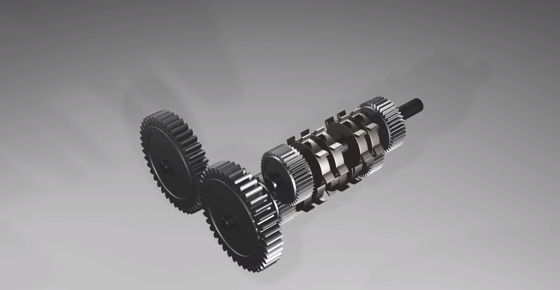 Ilustracja przedstawia kilka kół zębatych, połączonych w zespół.