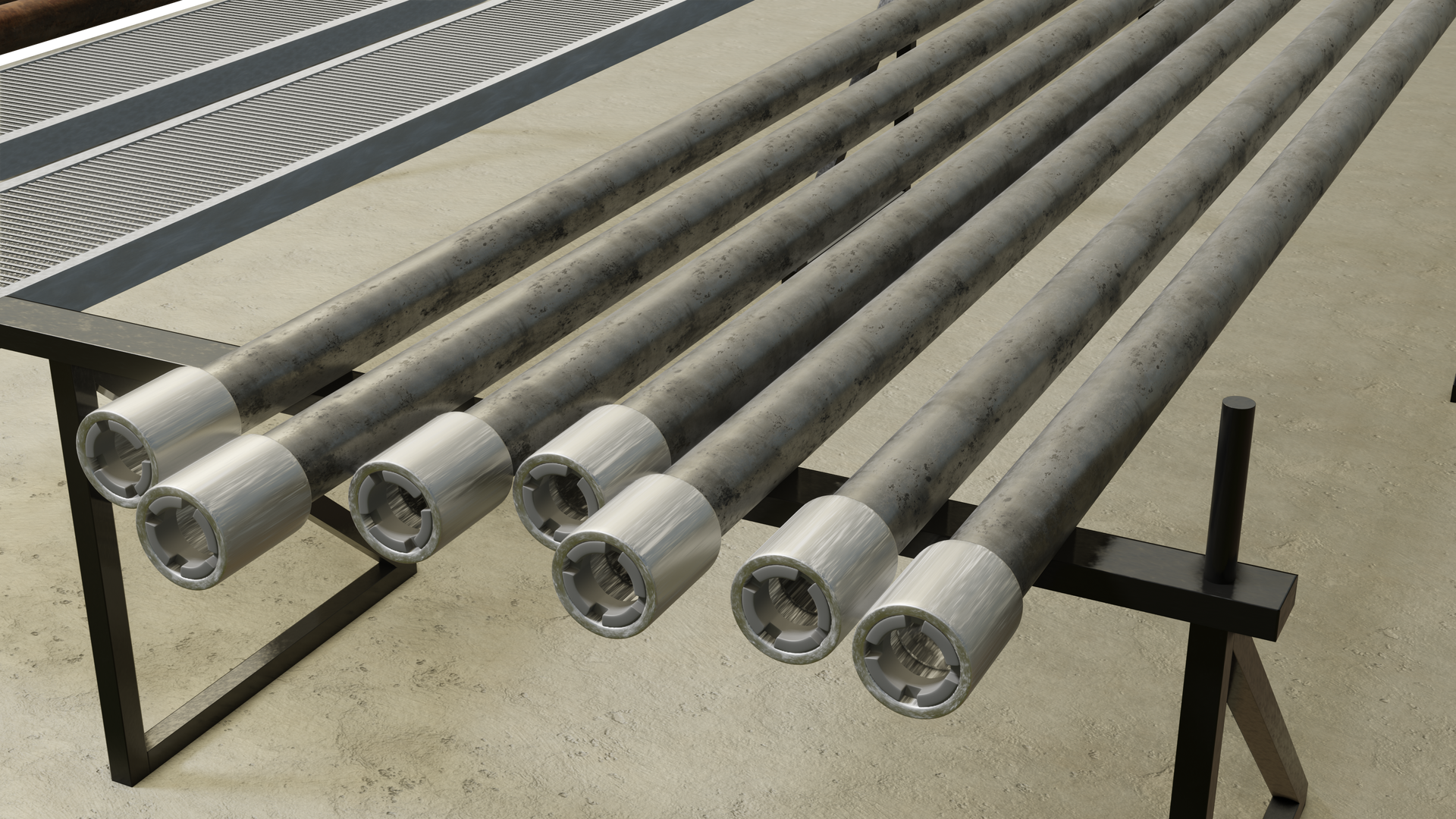 Na zdjęciu widoczne są przewody wiertnicze na rampie.Siedem przewodów są w kształcie podłużnych rur. Na zakończeniu rury znajduje się końcówka o kształcie cylindrycznym. Końcówka ma większą średnicę niż rura. Przewody leżą na stalowym stelażu.