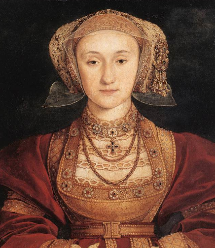 Ilustracja przedstawia portret Anny z Kleve (1515‑1557) - księżniczki niemieckiej, czwartej z kolei żony Henryka VIII Tudora. Kobieta ma jasną cerę, małe oczy, spokojny wyraz twarzy. Ma piękną suknię w złoto‑bordowym kolorze. Na głowie złote koronkowe nakrycie. 