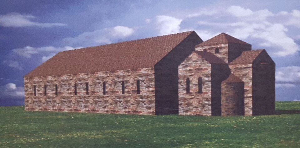 Zdjęcie przedstawia budynek. Ma spadzisty dach, małe okna, z prawej strony budynku są trzy wieże.  