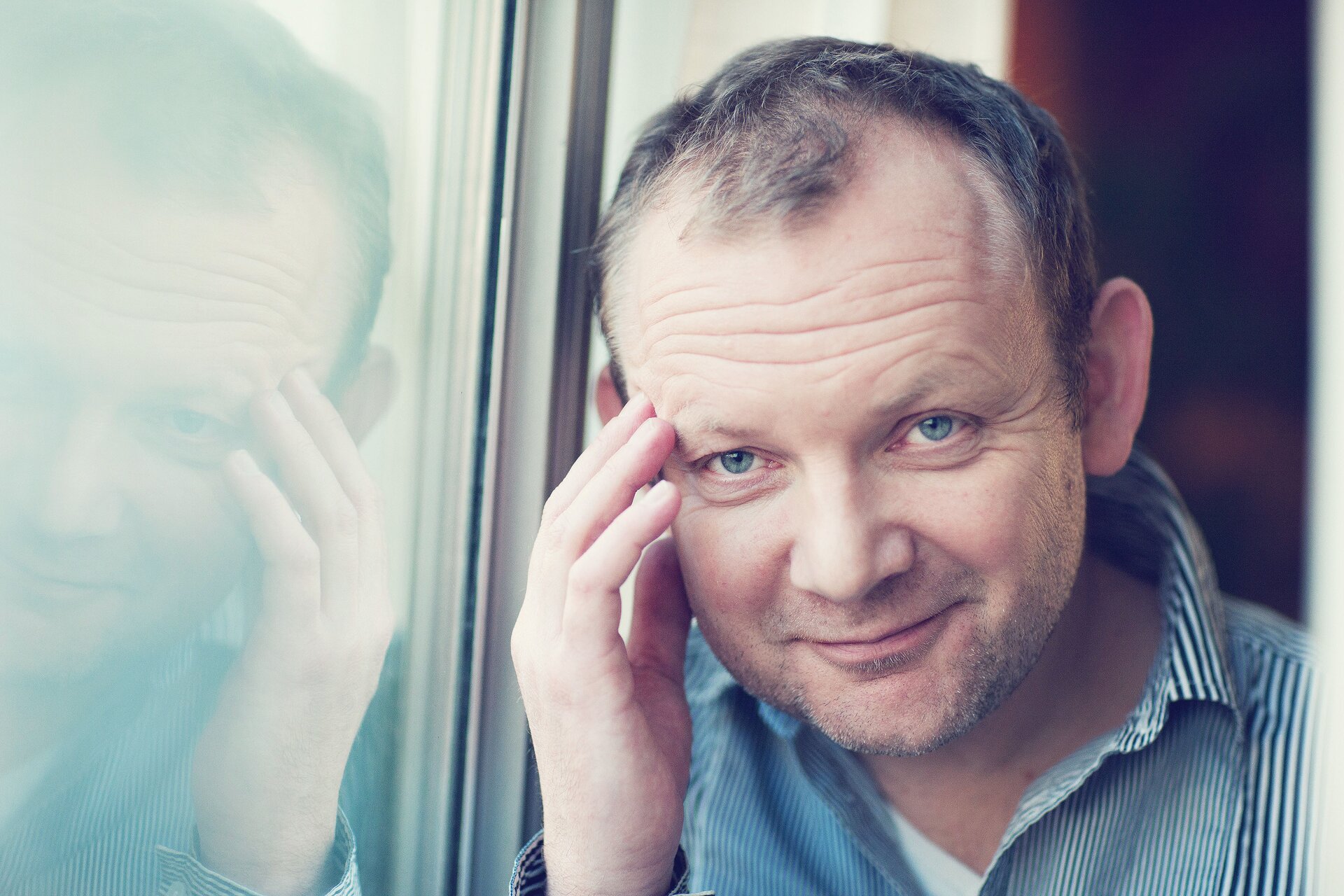 Ilustracja przedstawia podpartego Pawła Mykietyna, stojącego przy oknie.