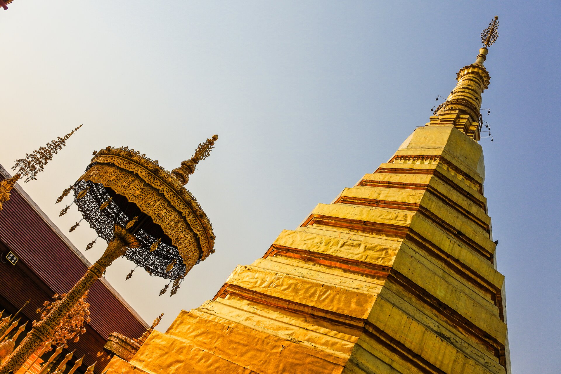 Zdjęcie przedstawia złotą świątynię w kształcie ostrego trójkąta.