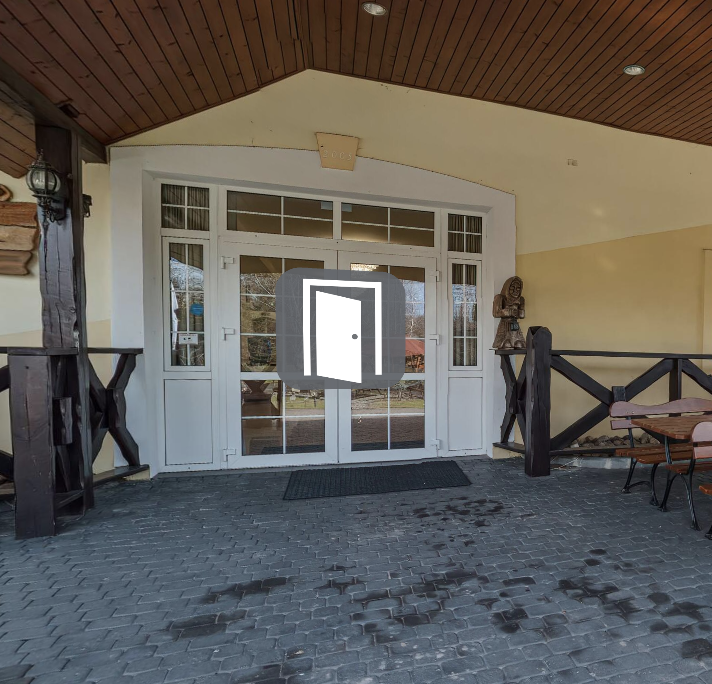 Zdjęcie przedstawia ikonę wejścia, na tle szklanych drzwi widoczna jest biała ikona uchylonych drzwi.