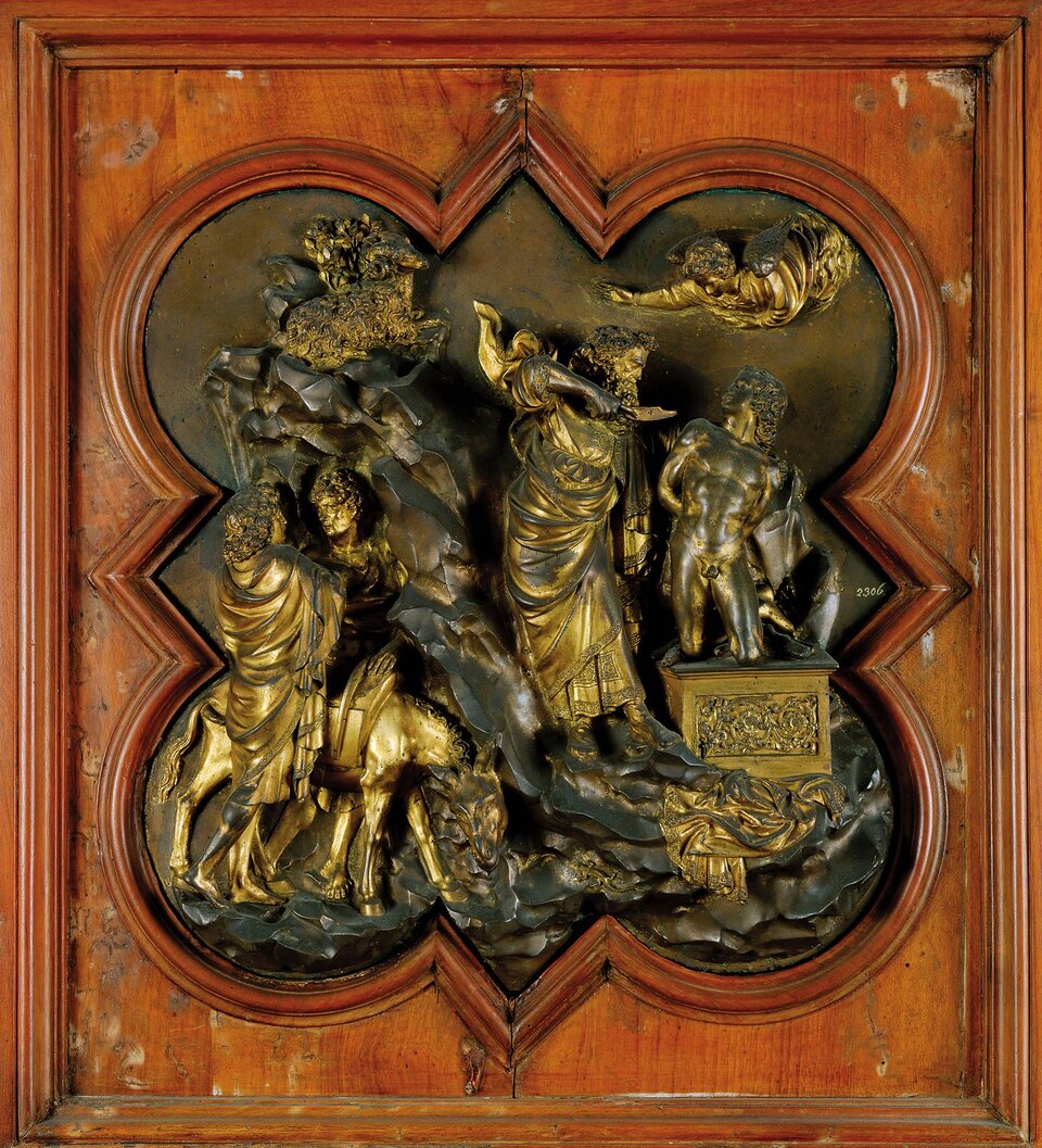 Ilustracja przedstawia dzieło Lorenzo Ghiberti pt. „Ofiarowanie Izaaka”. Na fragmencie drzwi baptysterium florenckiego widzimy rzeźbę ze sceną ofiarowania Izaaka - nagiego mężczyzny klęczącego na posagu. Obok niego stoi starszy mężczyzna w szatach, w ręku trzyma nóż, którym celuje w stronę Izaaka. Dookoła mężczyzn znajdują się inne postacie oraz zwierzęta. Cała scena przedstawiona jest w brązowej ramie.