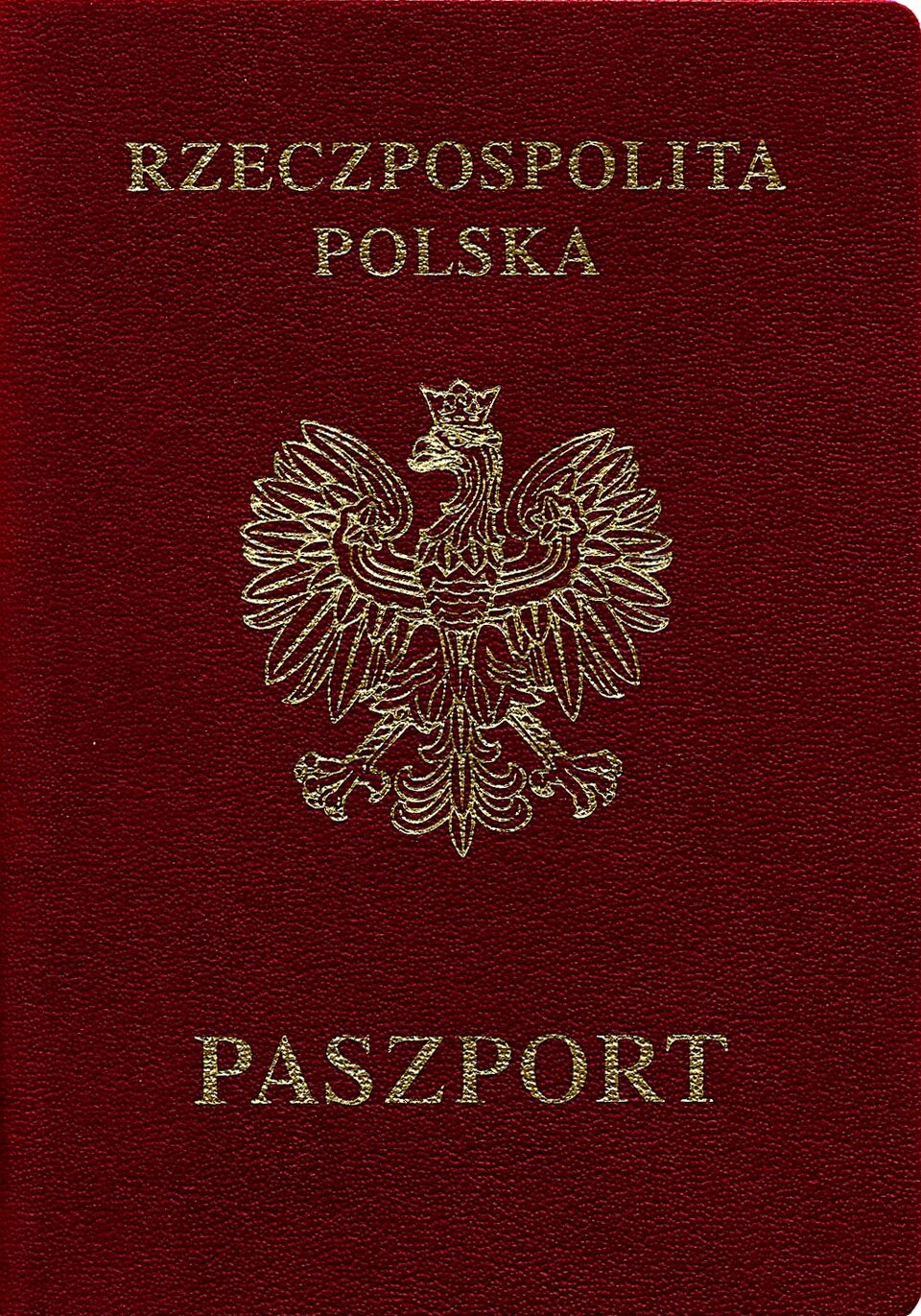 Kliknij żeby powiększyć Zdjęcie przedstawia paszport. Ma formę książeczki. Okładka paszportu ma kolor bordowy. Na okładce paszportu widoczne są napisy. W górnej części znajduje się napis: Rzeczpospolita Polska, w części dolnej napis: Paszport. W części środkowej wizerunek orła w koronie.