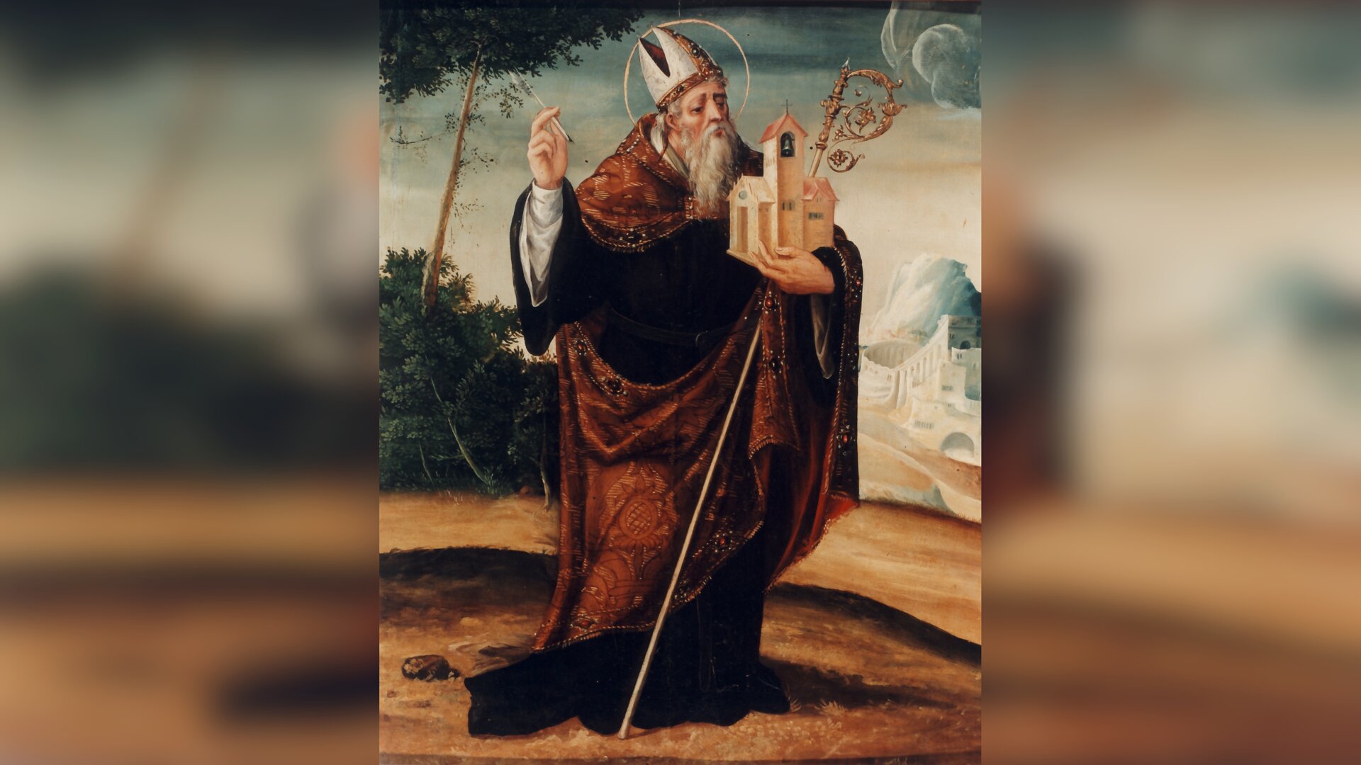 Obraz przedstawia postać starszego mężczyzny w stroju biskupim i tiarze na głowie. Mężczyzna trzyma w lewej dłoni pastorał i miniaturowy kościół, lewą ręką wykonuje gest błogosławieństwa.