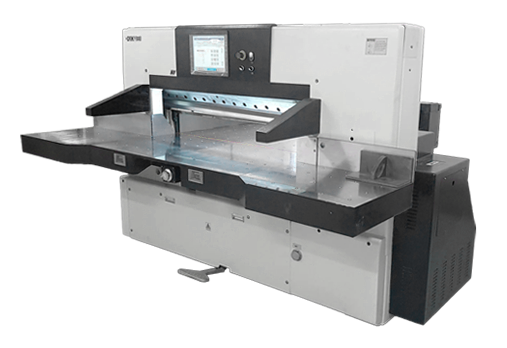 Grafika przedstawia krajarkę jednonożową. Posiada ona stolik oraz znajdujący się nad nim element ustalający i wskazujący odległość krojenia oraz element dociskowy.