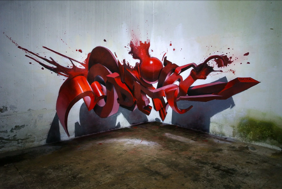 Ilustracja przedstawia graffiti Sergio Odeith'a. Ukazuje czerwony, rozpryskujący się napis zamieszczony w rogu ściany w taki sposób, że tworzy efekt trójwymiarowy. Na ścianie i podłodze został namalowany cień napisu.