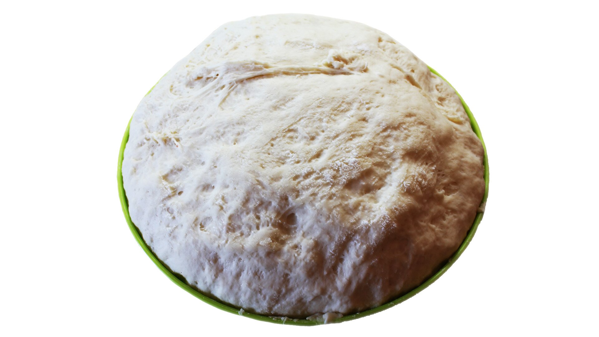 Zdjęcie przedstawia rozrost końcowy ciasta. Widoczne jest uformowana półkuliście ciasto na okrągłej zielonej podstawce. Na cieśnie widoczne są rozstępy i pęcherzyki powietrza. 