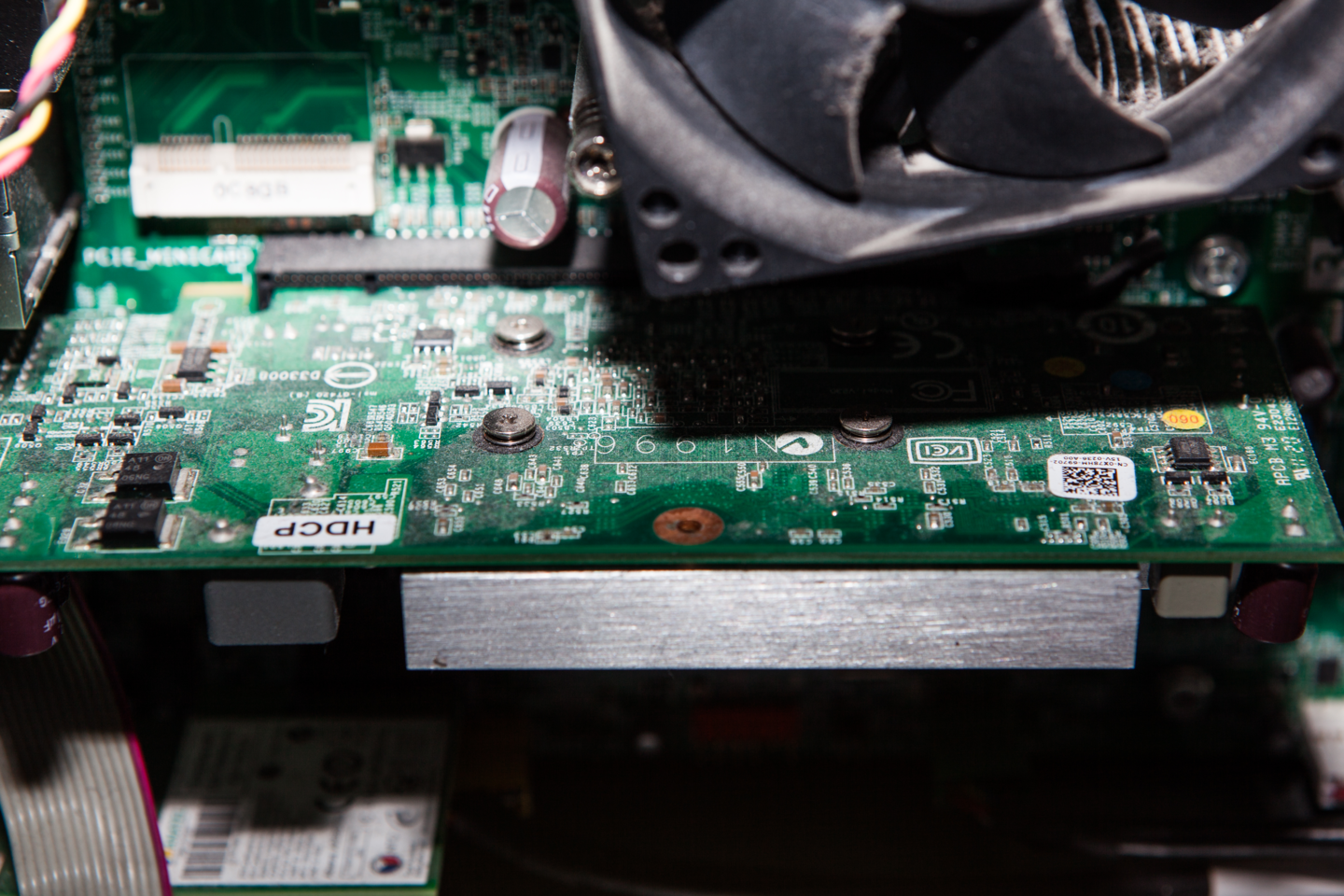 Fotografia przedstawia dysk z komputera z widocznymi układami elektronicznymi - na zielonej płytce drobne metalowe i plastikowe elementy.