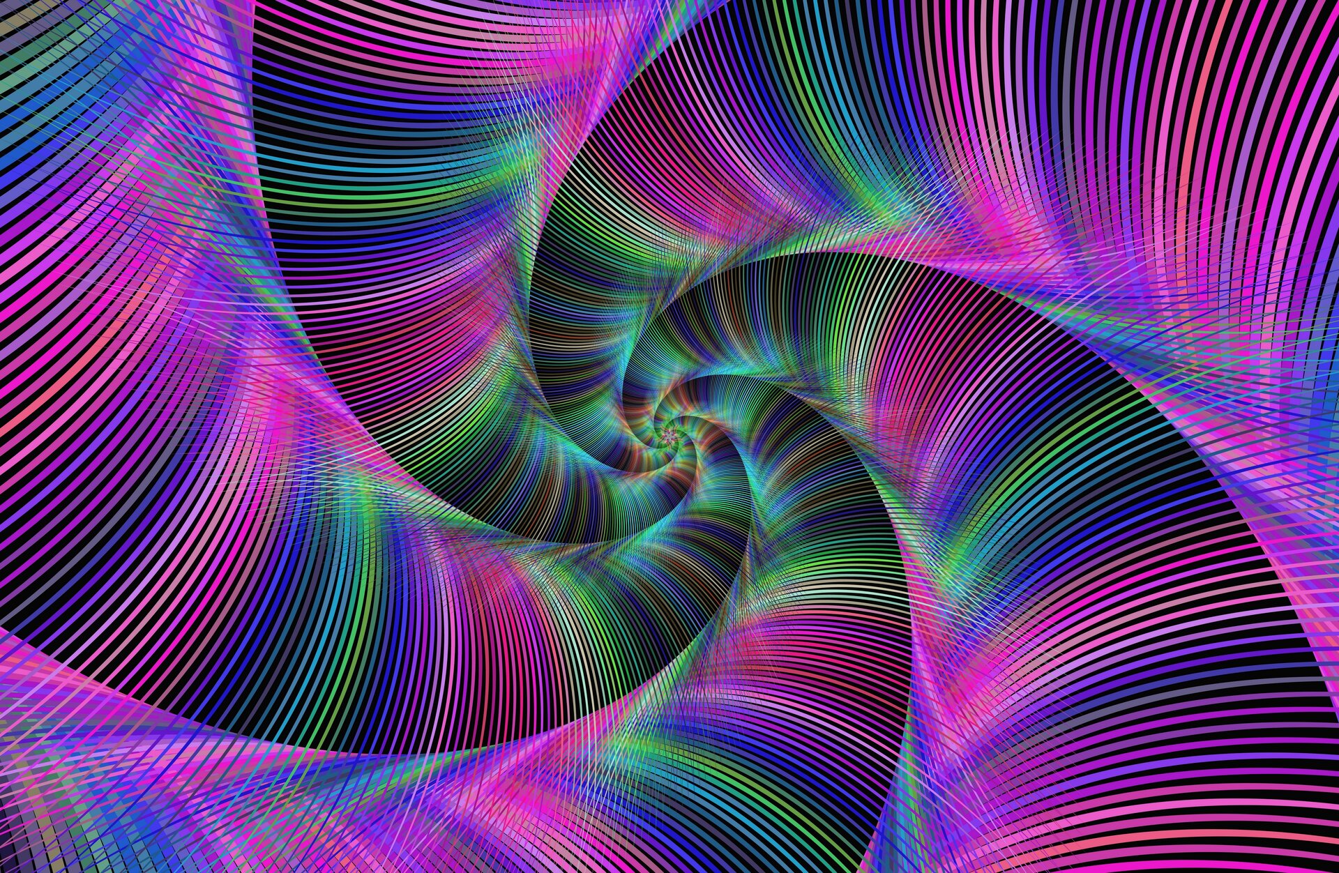 Ilustracja ukazuje grafikę komputerową przedstawiającą spirale. Kolorystyka jest wielobarwna jednak dominują fiolety i róże. Spirala składa się z kolorowych pasów zachodzących na siebie, zawijają się one na kształt muszli łącząc się w centrum grafiki. Środek spirali utrzymany w barwach błękitu i zieleni.