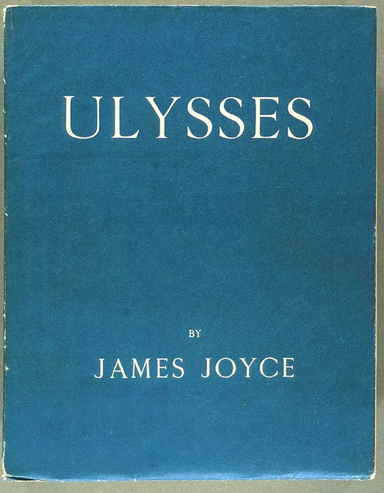 Ilustracja przedstawia oładkę książki z napisem ULYSSES by James Joyce. Okładka jest cała niebieska, a napisy białe.