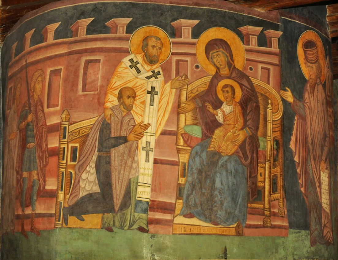 Na obrazie chrzest Jagiełły. Maryja siedzi na ozdobnym krześle, a na jej kolanach znajduje się mały Jezus. Unosi on prawą rękę ku górze, ma wyprostowany palec wskazujący i środkowy w geście błogosławieństwa. Przed nim klęczy mężczyzna wpatrujący w Jezusa. Obok mężczyzny stoi Józef w długiej szacie i białym szalu z czarnymi krzyżami. Za mężczyznami stoi strażnik trzymający włócznię. Za tronem stoi mężczyzna, który unosi prawą rękę ku górze. W tle widoczny mur.