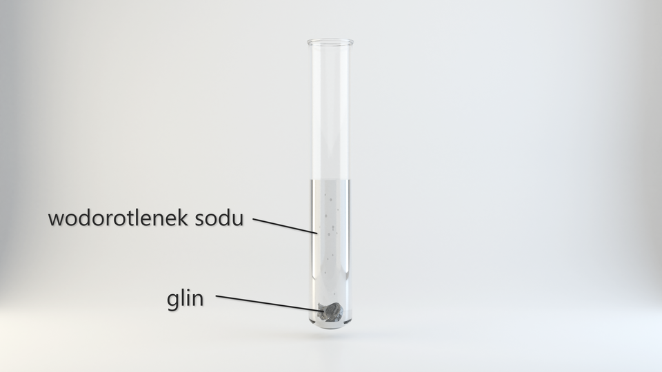 Ilustracja przedstawia probówkę z przeźroczystym roztworem wodorotlenku sodu i metalicznym glinem znajdującym się na dnie