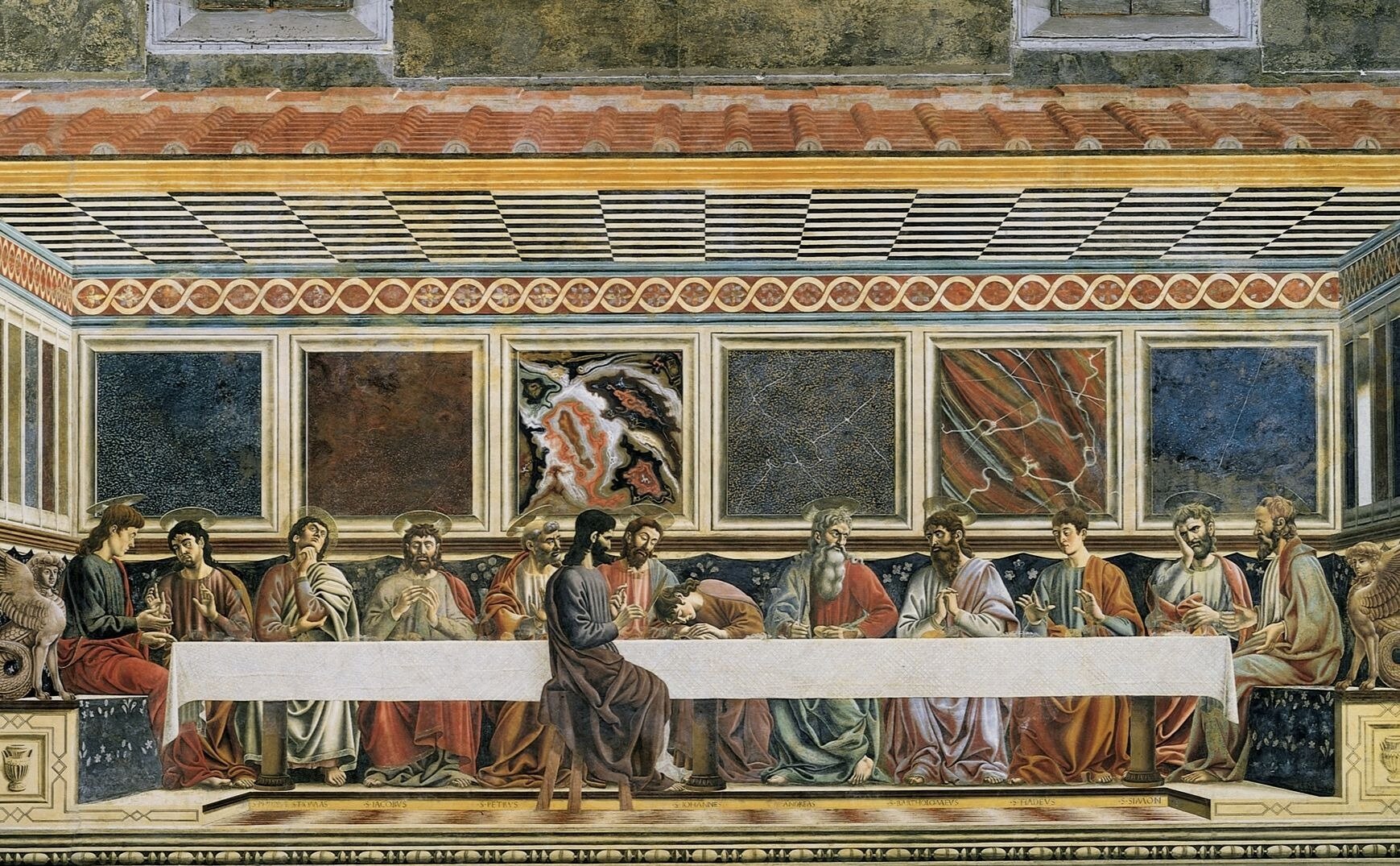 Obraz przedstawia kolejną wersję ostatniej wieczerzy. W centralnej części obrazu znajduje się kamienny stół. Przy stole  siedzi jedenastu mężczyzn w aureoli nad głowami. Centralną pozycję zajmuje Jezus. Mężczyźni – apostołowie gestykulują, patrzą na siebie, unoszą głowy w zadumie lub niedowierzaniu. Jeden z uczniów kładzie głowę na piersi Jezusa. Jeden z apostołów, odseparowany od reszty, siedzi bokiem po przeciwnej stronie stołu, naprzeciwko Jezusa, to Judasz, jest pozbawiony aureoli. Judasz jest ukazany z profilu, jego ciemniejszy od pozostałych biesiadników strój jest bardzo wyraźny na tle obrazu. 