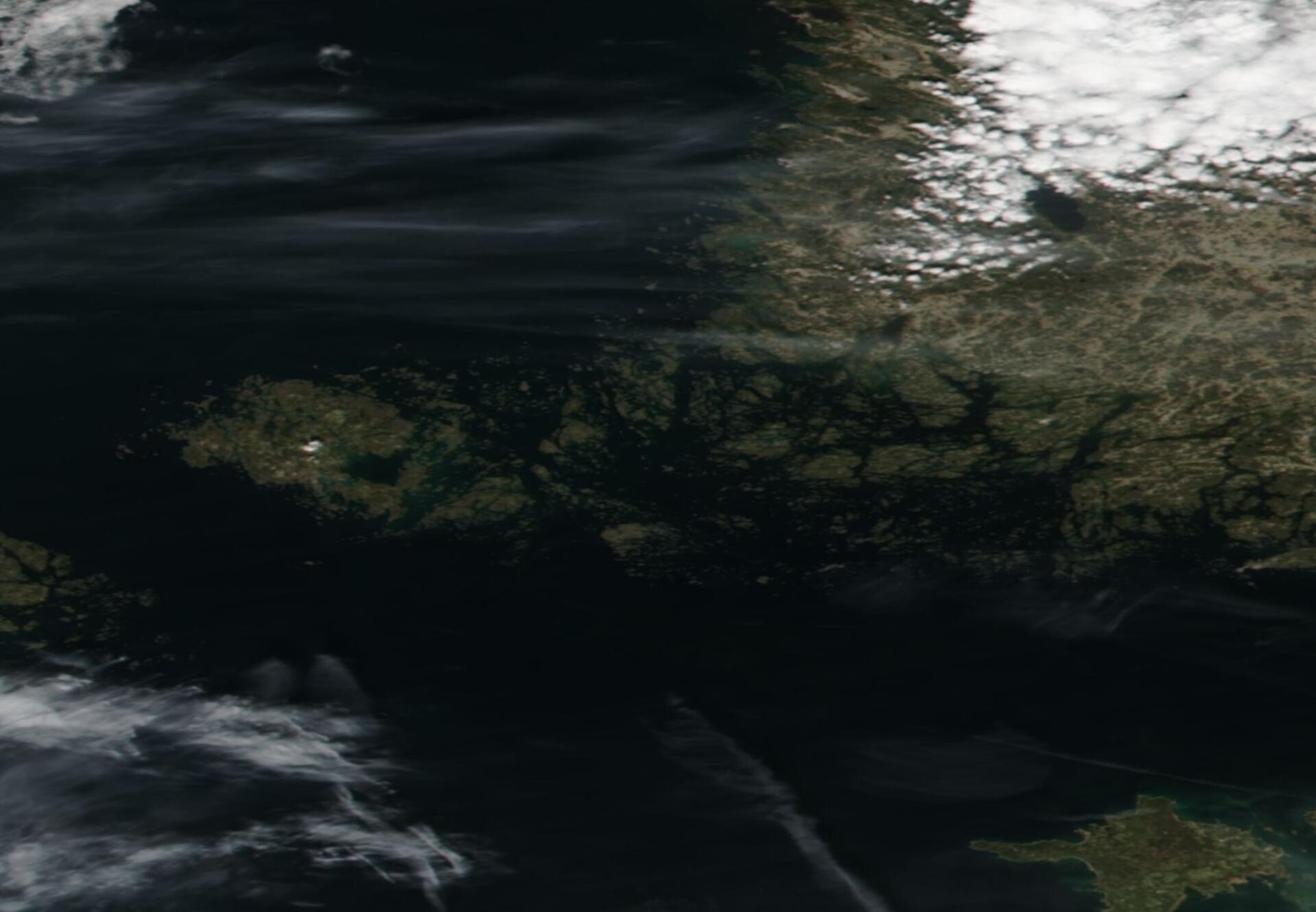 Zdjęcie satelitarne przedstawia liczne wysepki zgrupowane przy wybrzeżu, wokół nich jest woda.