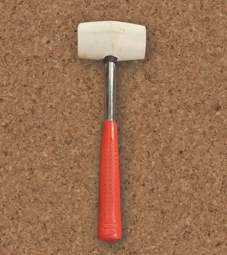 Zdjęcie przedstawia młotek gumowy. Składa się on z gumowej głowy oraz metalowej rękojeści pokrytej gumą. 
