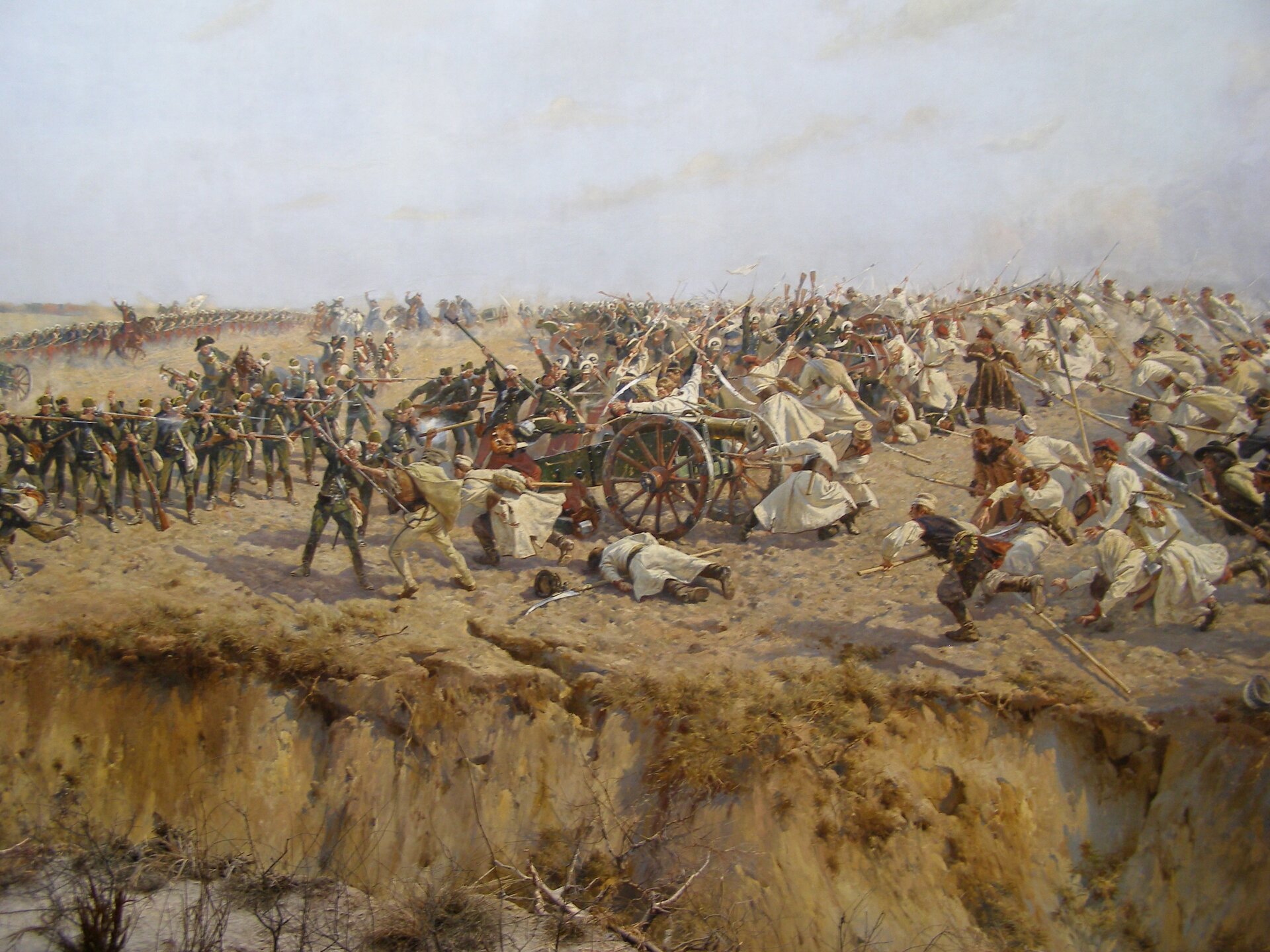 Obraz przedstawia kosynierów, którzy szturmują stanowiska rosyjskich armat. Bartosz Głowacki czapką gasi lont jednej z armat. Chłopi ubrani są w chłopskie koszule i uzbrojeni są w kosy. Część kosynierów walczy w zwarciu z obsługą armat, pozostała część jest w biegu. Za rosyjskimi armatami rosyjscy żołnierze stoją ze strzelbami i mierzą w nadbiegających chłopów. 