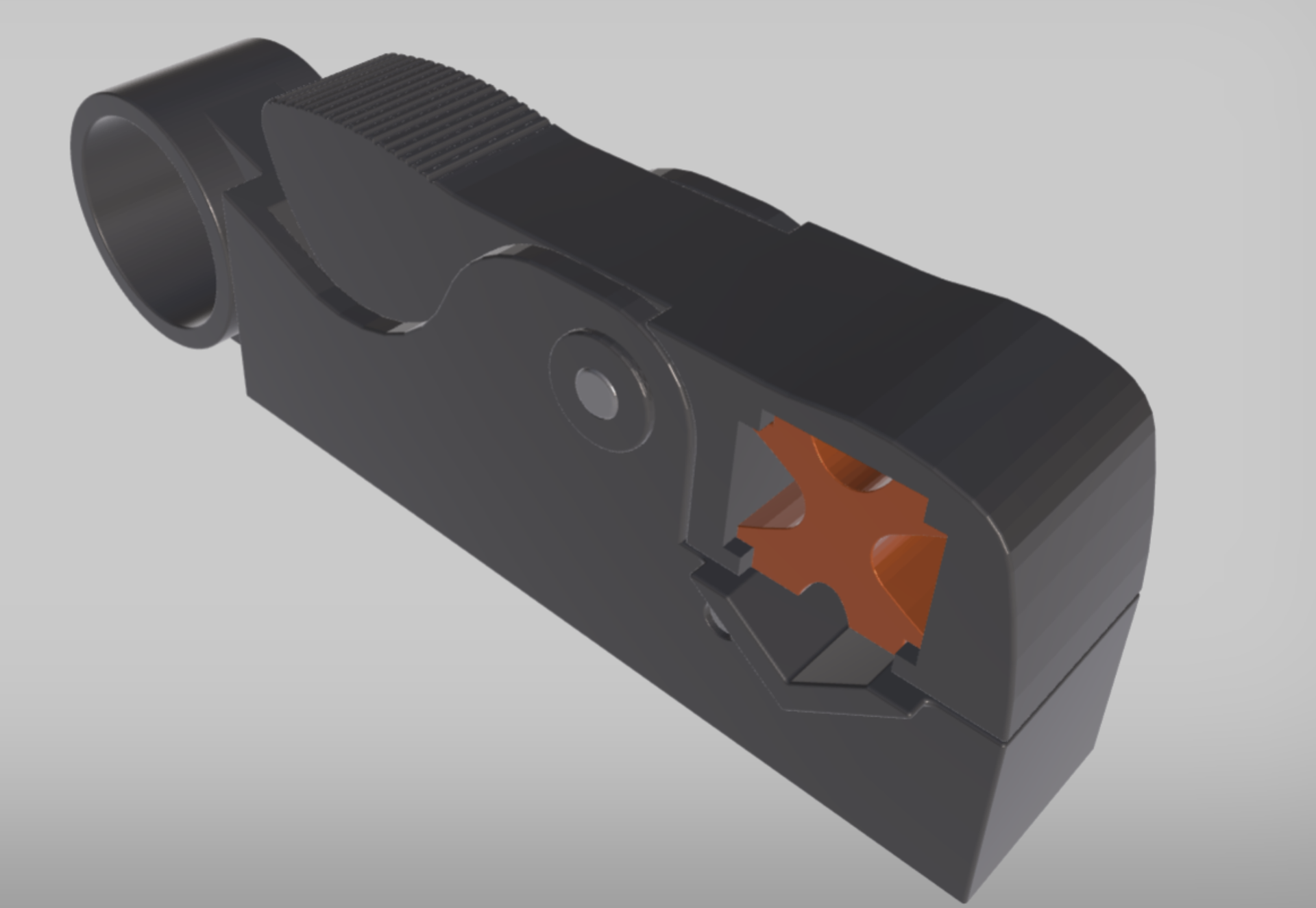 Grafika przedstawia narzędzie, które kształtem przypomina nożyczki. Posiada dwa regulowane uchwyty i otwór w części czołowej służący jako miejsce, w które wprowadza się kabel, gdy chcemy usunąć izolację.