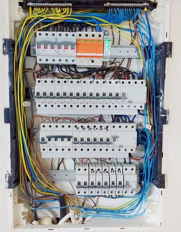 Zdjęcie przedstawia rozdzielnicę niskiego napięcia z zabezpieczeniami poszczególnych obwodów. Rozdzielnica składa się z czterech rzędów szyn montażowych. Na szynach zabudowano rozłączniki izolacyjne trójfazowe, ochronniki przeciwprzepięciowe odpowiedniej klasy, wskaźnik obecności napięcia. Na niższych szynach znajduje się zabezpieczenie różnicowo‑prądowe oraz zabezpieczenia nadmiarowo‑prądowe typu S. Każdy wyłącznik zabezpiecza jeden wydzielony obwód.
