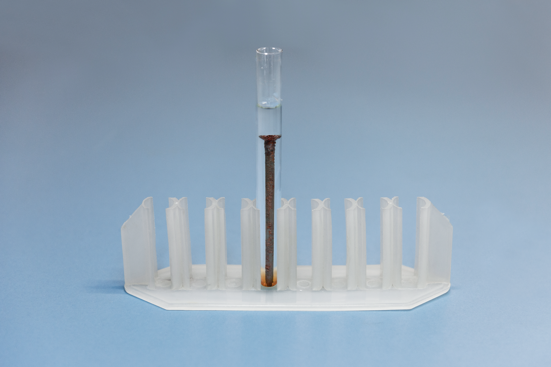 Czwarte zdjęcie w galerii przedstawia plastikowy stojak na probówki z jedną małą probówką. Probówka napełniona jest kwasem fosforowym(<math aria‑label="pięć">V), do którego nieco wcześniej wrzucono duży, zardzewiały gwóźdź. Po pewnym czasie można zaobserwować zniknięcie części rdzy i odsłonięcie czystego metalu. W dolnej części probówki płyn przybrał brązowy kolor od osadu.
