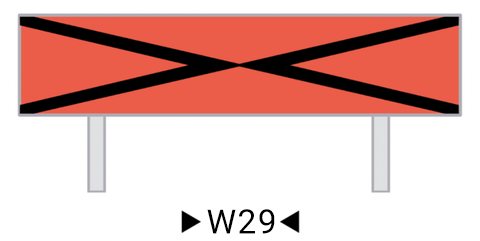 Wskaźnik wu dwadzieścia dziewięć. Prostokątna czerwona tablica na której znajdują się dwa czarne kąty oparte na krótszym boku prostokąta, stykające się wierzchołkami w środku prostokąta.