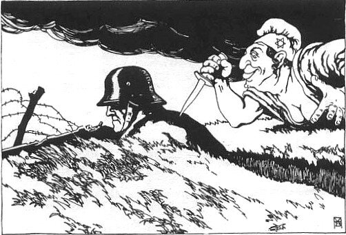Ilustracja przedstawia karykaturę. W okopie siedzi żołnierz w hełmie. Wystawia karabin. Za jego plecami jest kobieta z czapką z gwiazdą żydowską na boku. W prawej dłoni trzyma krótki sztylet.