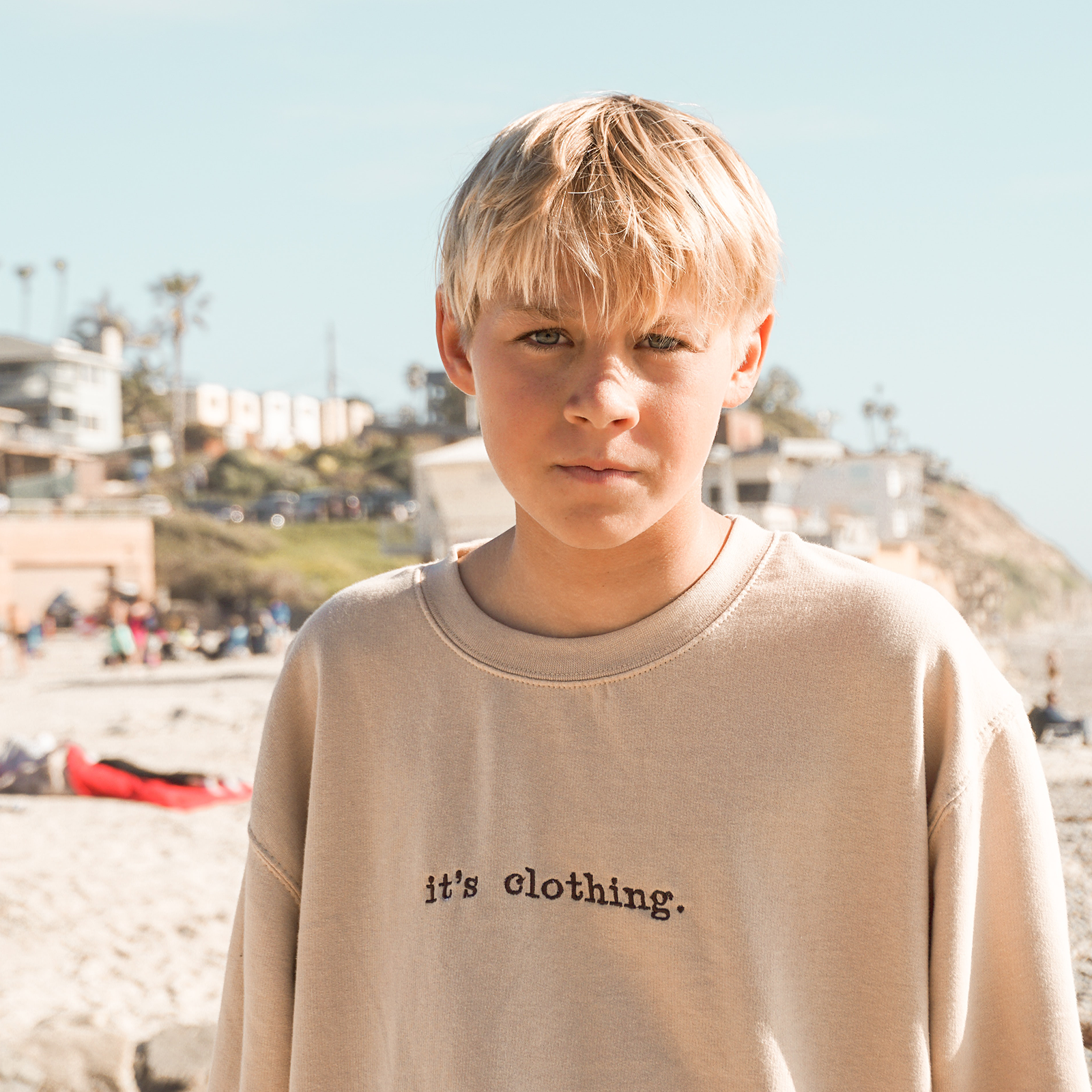 Zdjęcie przedstawia chłopca w wieku szkolnym o blond włosach i niebieskich oczach. 