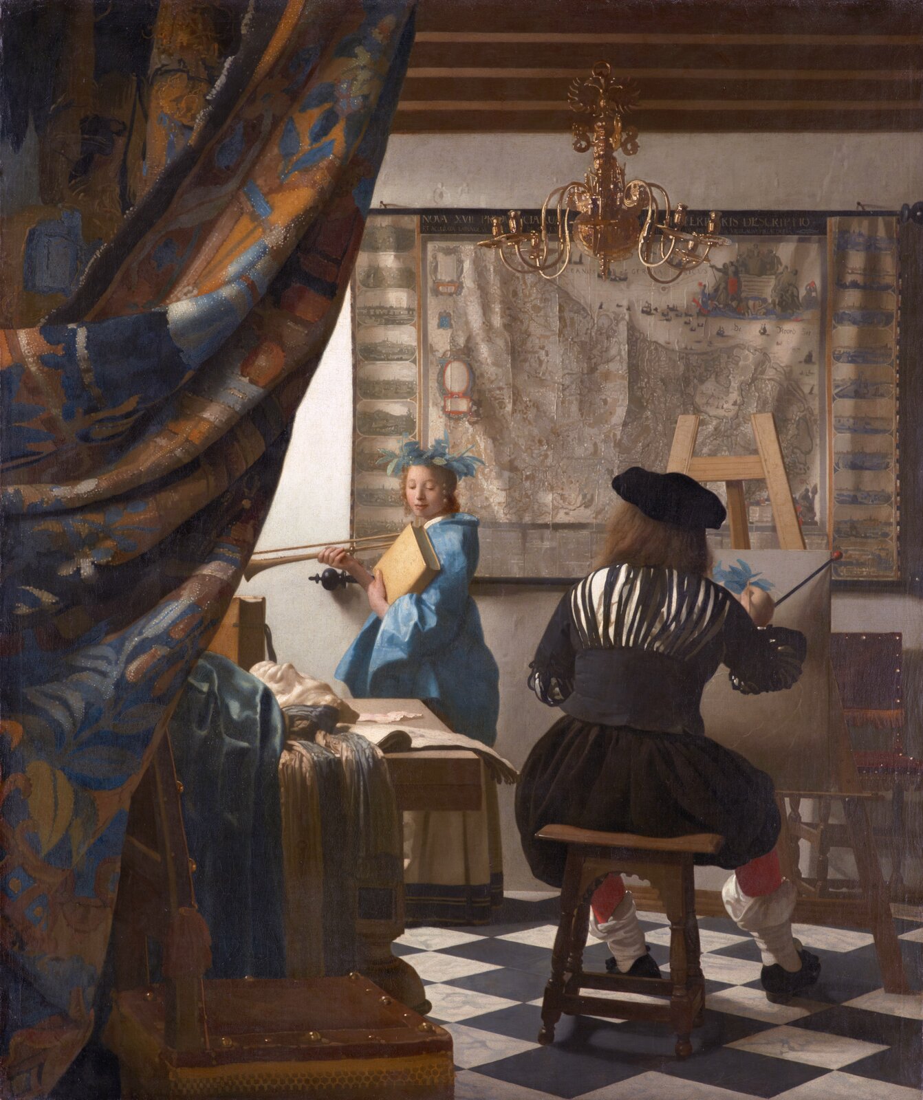 Ilustracja o kształcie pionowego prostokąta przedstawia obraz autorstwa Jana Vermeera van Delft „Alegoria malarstwa”. Obraz przedstawia artystę siedzącego przed sztalugą, tyłem do widza. Artysta maluje modelkę. Dziewczyna ubrana jest w niebieską suknię z żółtą spódnicą. Jej głowa jest zwrócona w stronę malarza. Sufit wykonany jest z drewnianych belek w brązowym kolorze, na których wisi bogato zdobiony żyrandol.  Po lewej stronie obrazu widoczna jest barwna kotara. 
