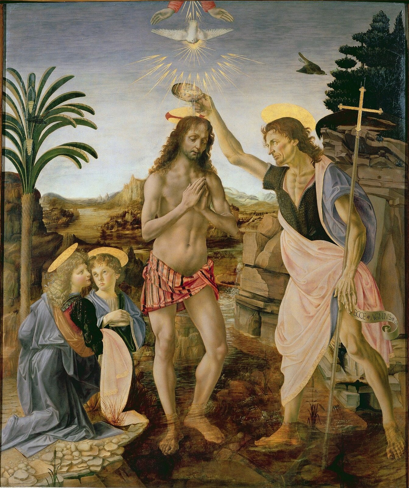Ilustracja przedstawia obraz „Chrzest Chrystusa” Verrocchia o kształcie pionowego prostokąta, namalowany z udziałem Leonarda da Vinci. Dzieło przedstawia scenę religijną, pośrodku znajduje się Chrystus ze złożonymi rękoma, nad nim Duch Święty oraz ręce Boga. Z prawej strony stoi Jan Chrzciciel, trzyma w lewej dłoni krzyż, a prawą polewa głowę Zbawiciela wodą z Jordanu. Z lewej strony klęczą dwa anioły. Scena ukazana jest na tle pejzażu z palmą po lewej stronie i skałą po prawej oraz pogodnym niebem.  