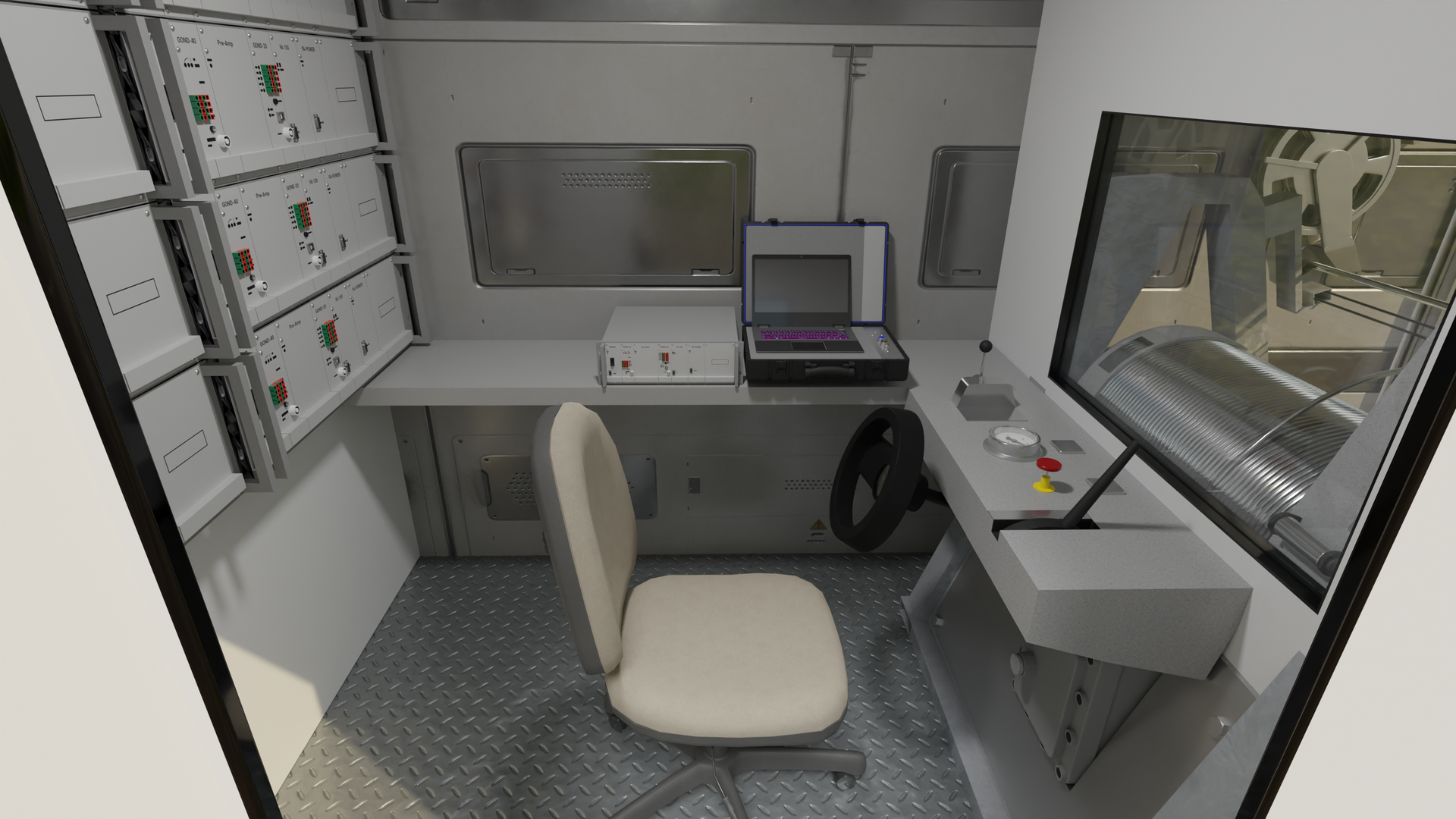Na zdjęciu przedstawiono wnętrze sterowni urządzenia sterująco‑rejestrującego. Biurko widoczne w przyczepie jest w kształcie litery L. Przy biurku stoi krzesło. Po prawej stronie widoczna jest mała czarna kierownica, dźwignia i kolorowe przyciski. Nad pulpitem znajduje się szyba w ścianie. Na drugiej części biurka leży walizka z aparaturą. Po przeciwnej stronie biurka widoczna jest biała ściana na której zamontowane są pulpity z przyciskami