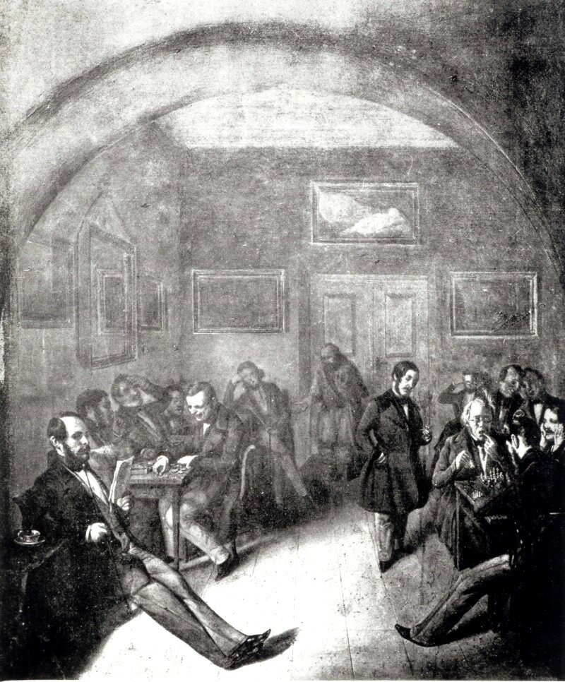 Obraz przedstawia wnętrze kawiarni. Przy stolikach siedzą mężczyźni w surdutach. Rozmawiają ze sobą, grają w gry planszowe, czytają gazetę. Są podzieleni na kilka grup. Na niebieskich ścianach wiszą obrazy oraz lustro. Widoczne są białe drzwi, przy których stoi mężczyzna w ciemnym, skromnym stroju. Wyciąga rękę do siedzących obok osób.