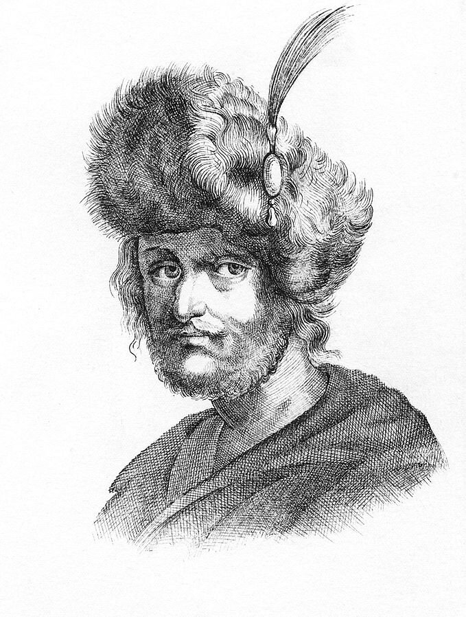 Ilustracja przedstawia portret mężczyzny z wąsami i brodą. Na głowie ma futrzaną czapkę z przypiętym piórem.
