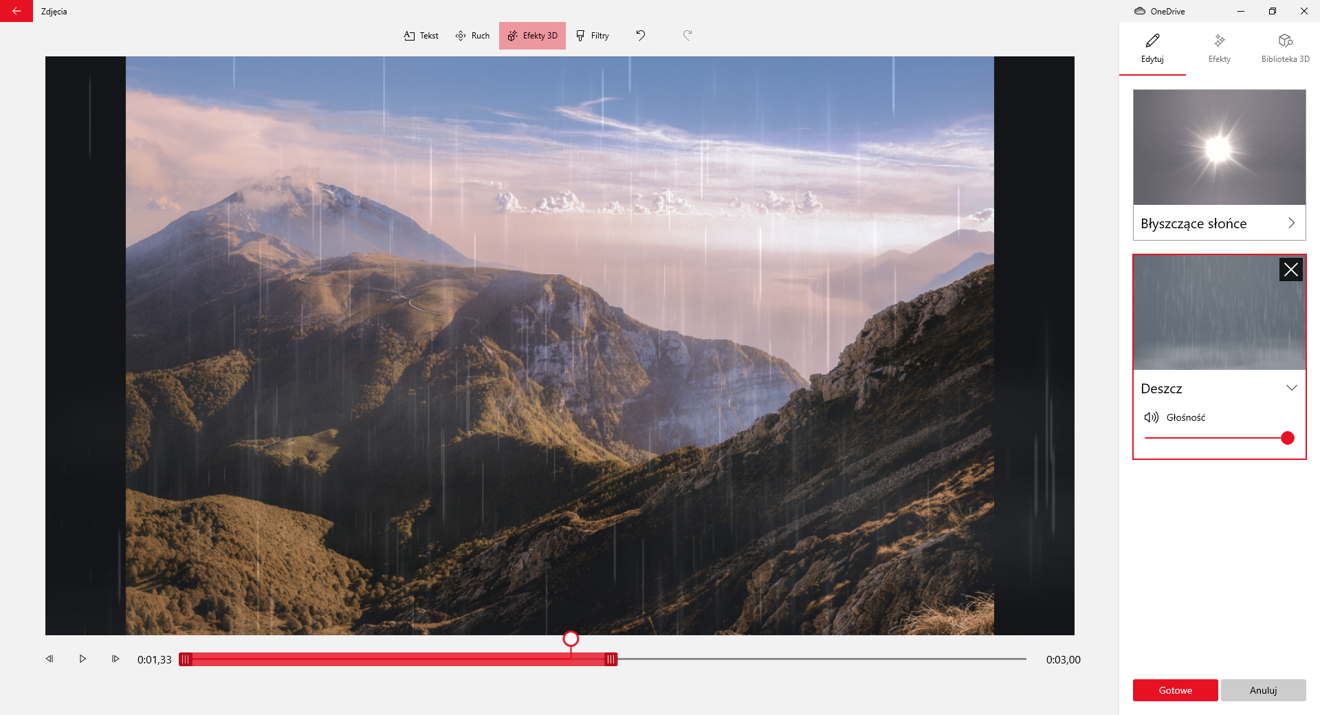 Na zrzucie ekranu przedstawiono sposób zastosowania efektu deszczu dla zdjęcia w aplikacji Edytor Wideo.W górnej części aplikacji znajduje się przycisk z symbolem strzałki skierowanej w lewo oraz napis: zdjęcia. Obok widoczne są przyciski: tekst, ruch, efekty trzy de, filtry. Przycisk efekty trzy de jest wciśnięty. Poniżej przycisków znajduje się okno edycji filmu. Główną cześć okna stanowi prostokątny obszar na którym wyświetlany jest film lub zdjęcie. Przykładowo jest to klatka filmowa na której widoczne są góry podczas deszczu. Pod obszarem filmowym umieszczony jest suwak pokazujący czas trwania. Na suwaku jest okrągły znaczki czasu. Znacznik jest umieszczony w połowie czasu trwania filmu.Po lewej stronie suwaka znajduje się przycisk z narysowanym grotem strzałki skierowanym w lewo, przycisk play, przycisk z narysowanym grotem zwróconym w prawo oraz informacja o czasie trwania filmu. Z prawej strony suwaka widoczna jest informacja z czasem trwania filmu.Z prawej strony aplikacji znajduje się okno edycyjne efektów trzy de. W oknie efektów widoczna jest miniatura z zaznaczonymi obszarami. Pod pierwszą miniaturą znajduje się napis: błyszczące słońce. Druga miniatura jest opisana słowem deszcz. . Pod napisem jest symbol głośnika oraz suwak głośności. Suwak głośności jest ustawiony na maksymalny poziom. Druga miniatura jest zaznaczona. Poniżej umieszczone są dwa przyciski. Czerwony z napisem: gotowe, oraz szary z napisem: anuluj.