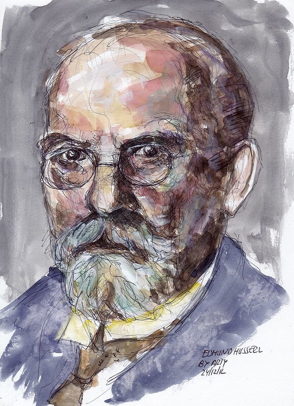 Portret mężczyzny w średnim wieku. Mężczyzna łysieje, ma wysokie czoło i gęstą brodę, nosi okulary. Ubrany jest w garnitur.  