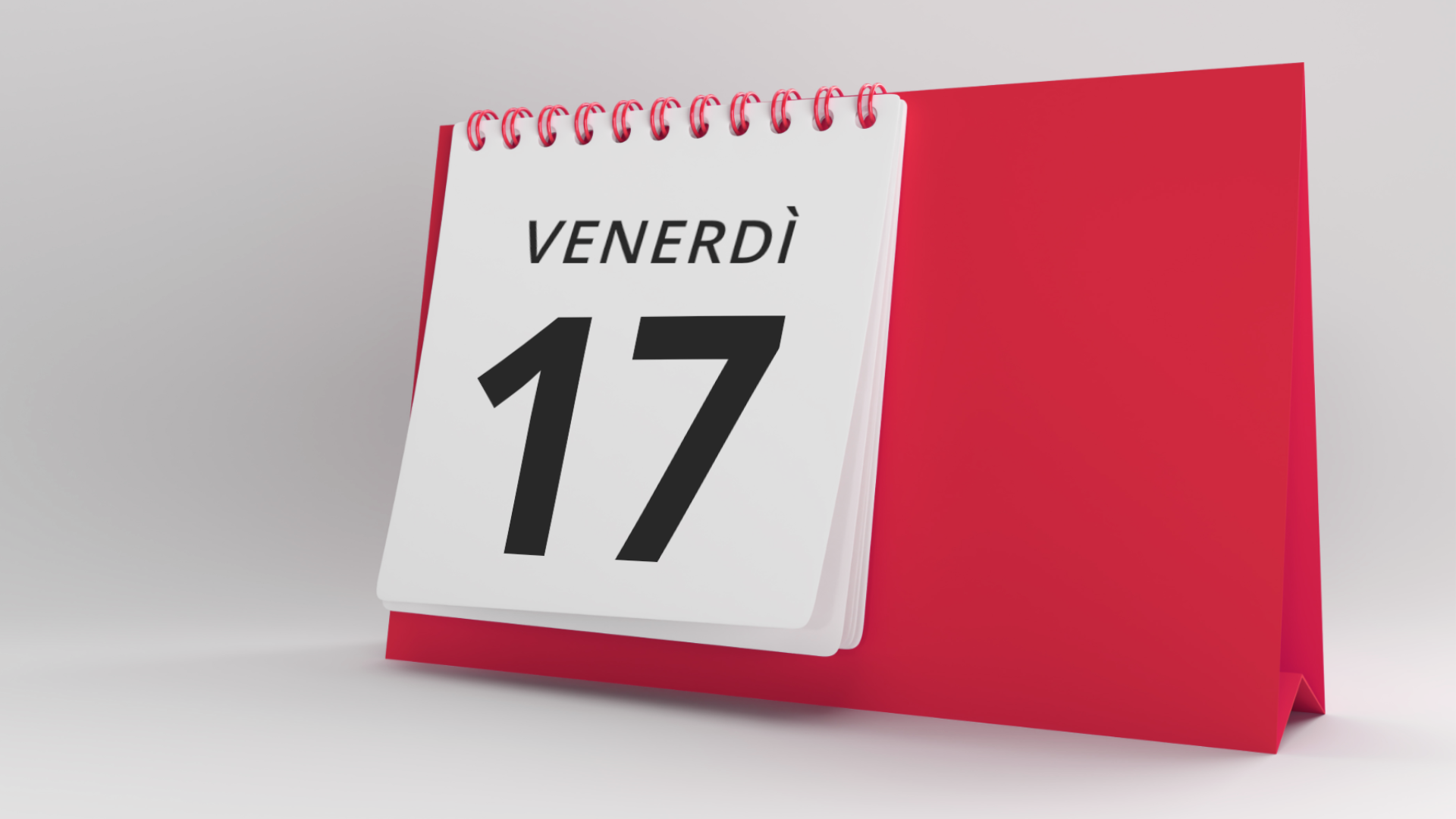 Grafika przedstawia kalendarz biurkowy. Na kalendarzu znajduje się karta z datą: Venerdì 17.
