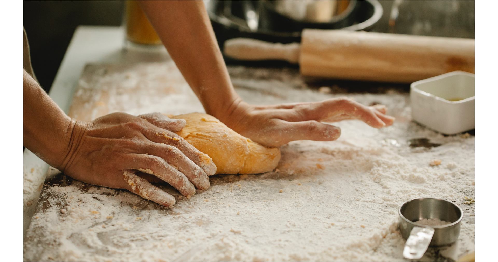 Zdjęcie przedstawia ręce osoby zagniatającej ciasto.