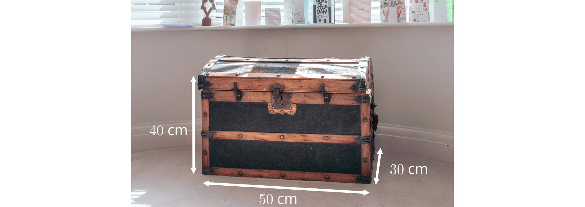 Ilustracja przedstawia piracką skrzynię skarbów. Na zdjęciu zaznaczone są wymiary skrzyni. Wysokość 40 cm, szerokość 30 cm i długość 50 cm.