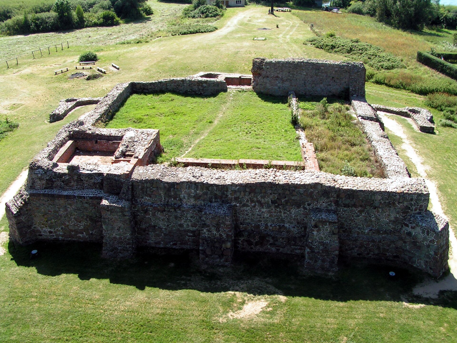 Zdjęcie przedstawia obecny widok zamku w Wenecji z lotu ptaka. Widoczny jest zarys fundamentów murów obronnych, zbudowanych na planie czworoboku. Wytyczały one zasięg murów zamku. Wewnątrz znajdował się dziedziniec. Ponadto widoczne są zarysy fundamentów dwóch wież obronnych., z lewej strony murów oraz na wprost na zdjęciu.