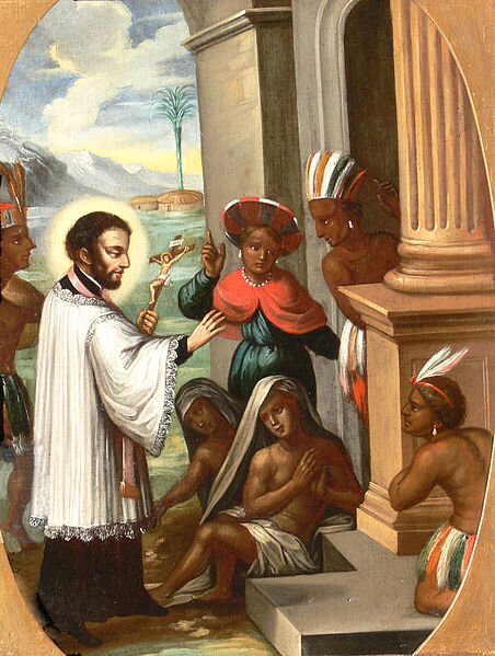 Ilustracja przedstawia kapłana w białej albie, z krzyżem w lewej ręce nawracającego pogan. Na przeciwko niego czarnoskórzy ludzie. Rzecz dzieje się u wejścia do świątyni. W tle rajski pejzaż z zieloną palmą. 