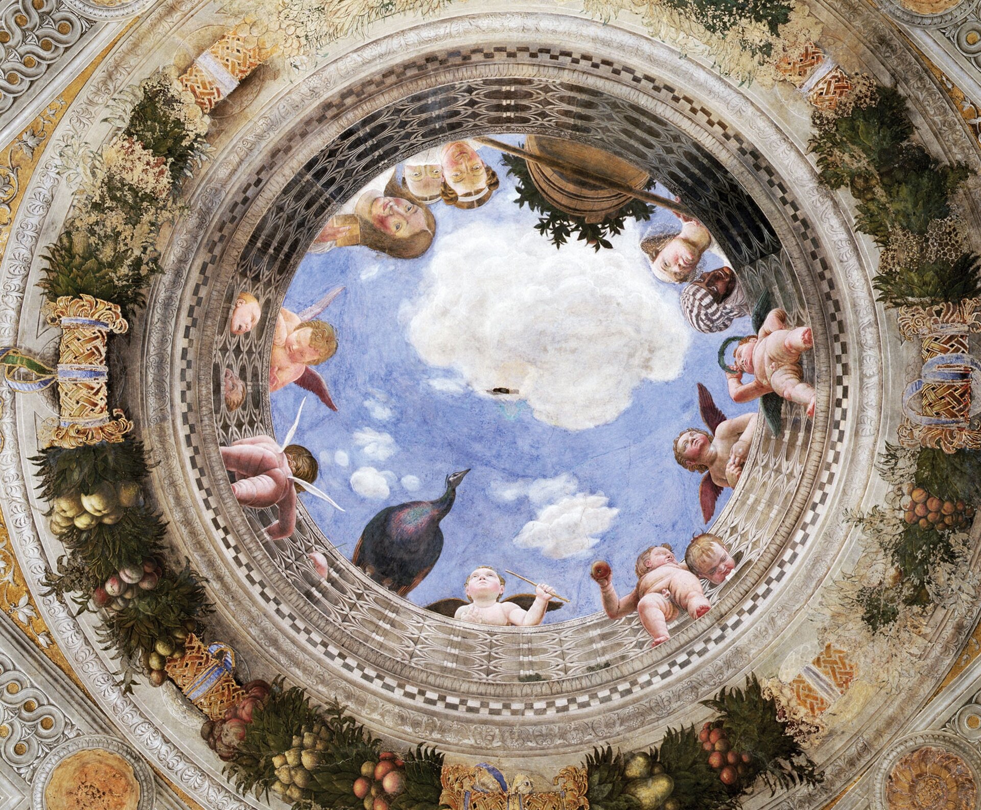 Ilustracja przedstawia pracę Andrea Manegna Oculus sklepienia w Camera degli Sposi. Fresk przedstawia spoglądające z góry postacie. Wśród nich widać dzieci (amory), ptaka, oraz osoby starsze. Pod postaciami widoczne są owoce. Nad postaciami widoczne jest niebieskie niebo z białymi chmurami.