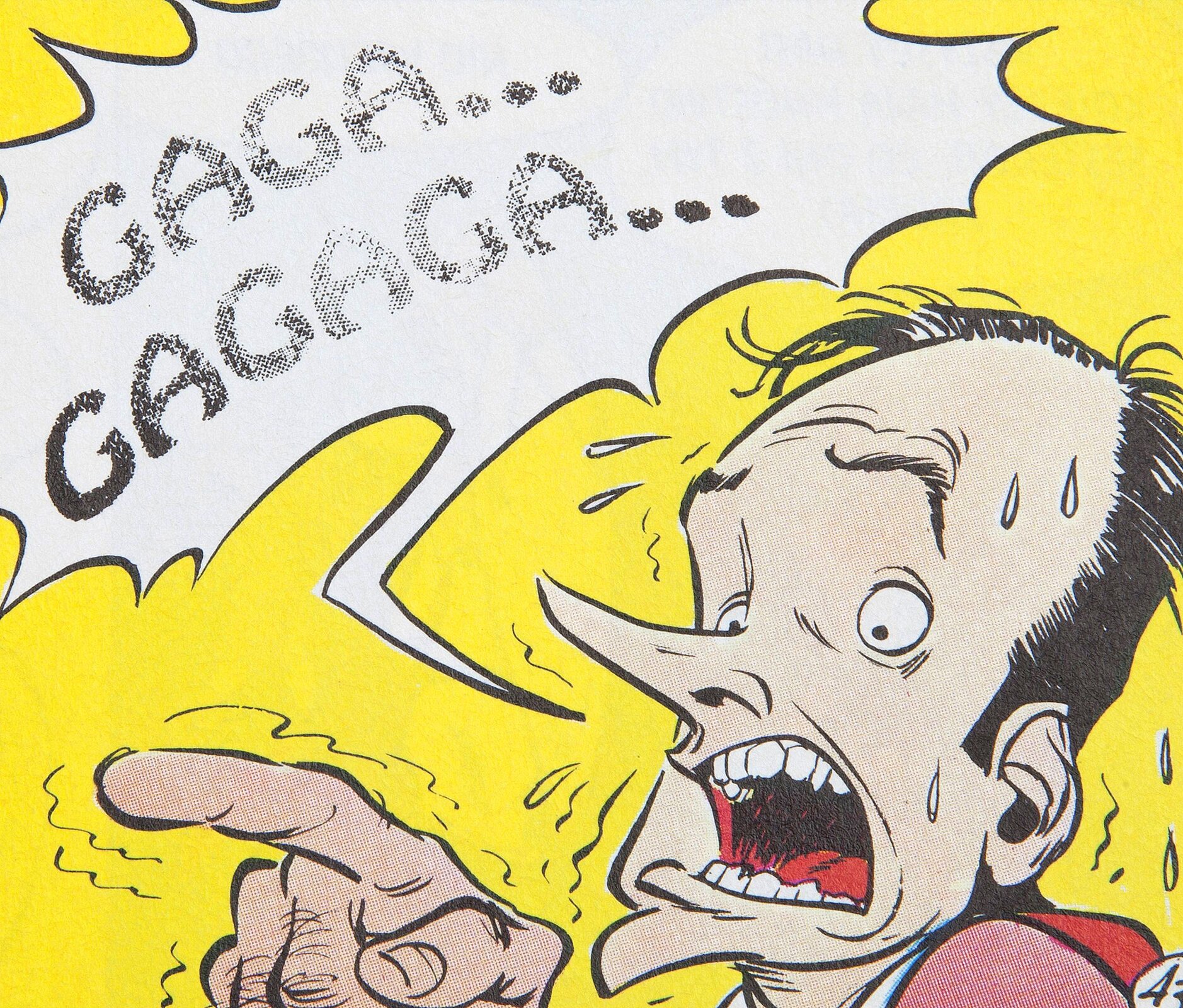 Ilustracja z komiksu. Ukazuje łysiejącego, przerażonego mężczyznę na żółtym tle, wskazującego przed siebie drżącym palcem. Jego usta są szeroko otwarte, a z jego skroni kapie pot. Obok niego znajduje się kanciasty dymek z tekstem: Gaga... Gagaga...