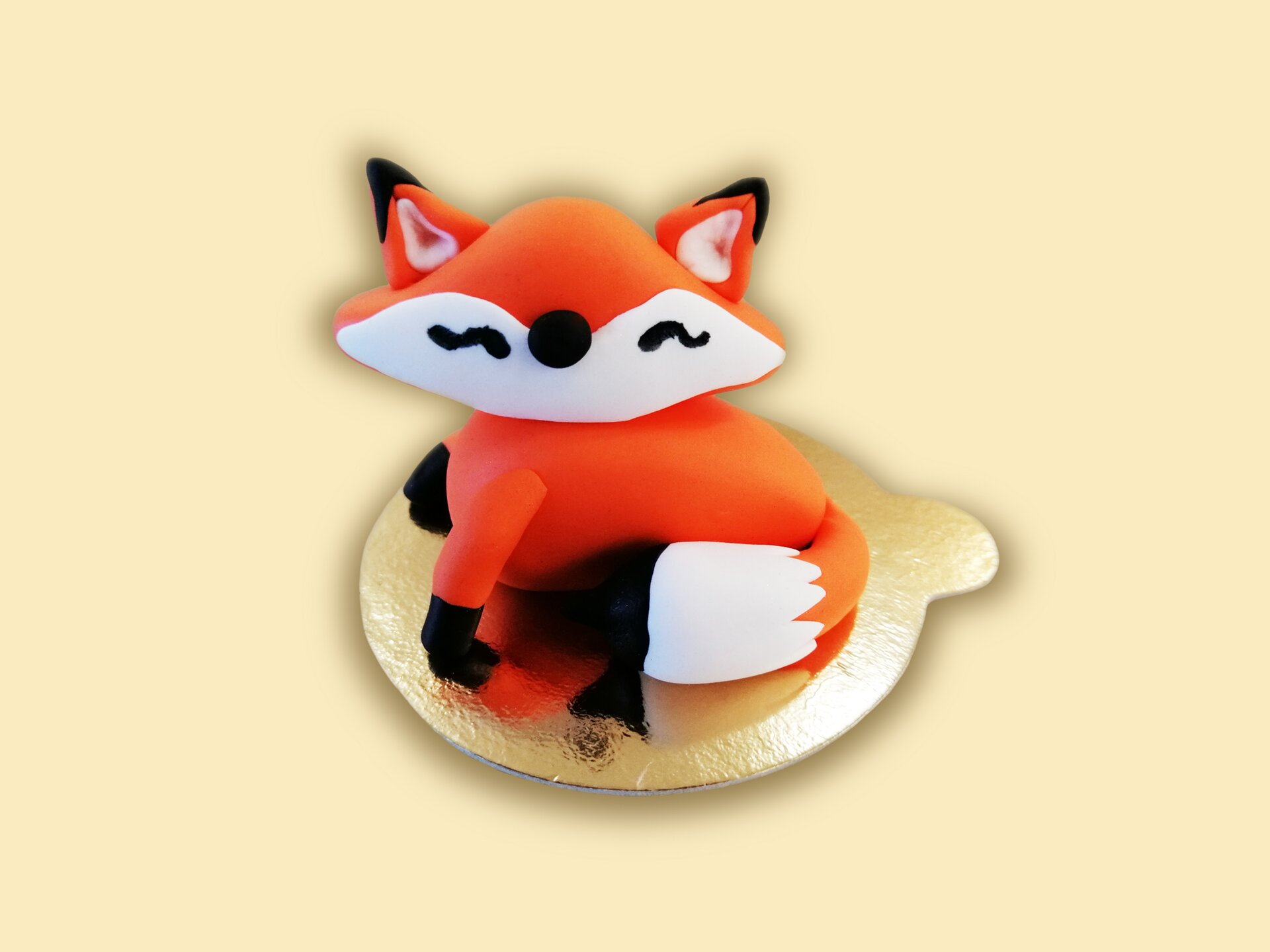 Figurka siedzącego lisa z masy cukrowej.