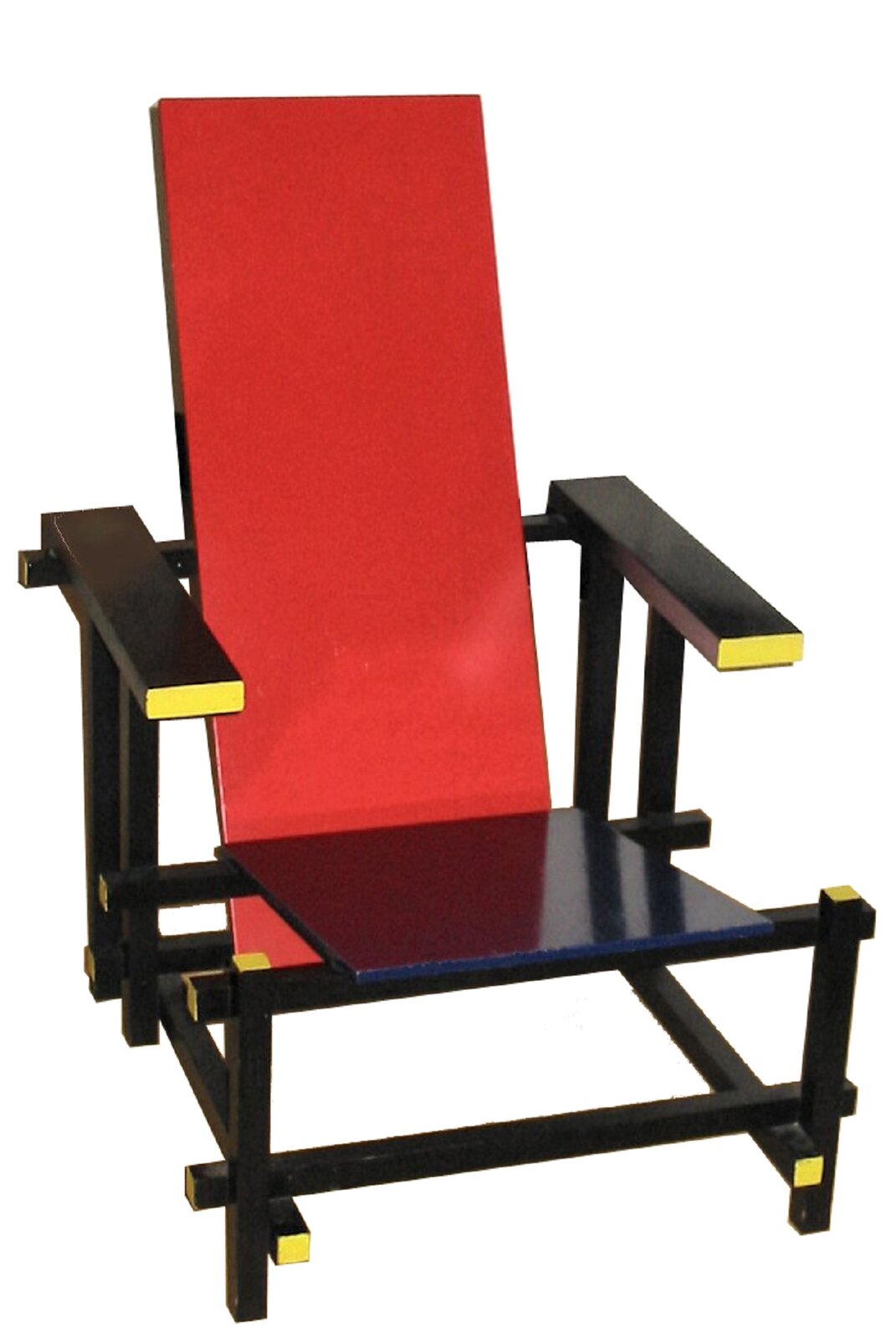 Fotografia przedstawia czerwono-niebieskie krzesło projektu Gerrita Rietvelda, stojące na czarnych nogach z żółtymi  elementami. Krzesło posiada czerwone drewniane oparcie oraz niebieskie drewniane siedzisko i czarno-zółte podłokietniki.