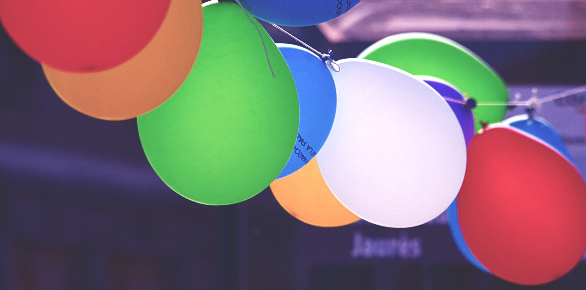  Zdjęcie przedstawia dziesięć balonów podwieszonych jeden przy drugim na sznurku. Każdy z nich posiada określony kolor: czerwony, jasnobrązowy, zielony, biały, niebieski.